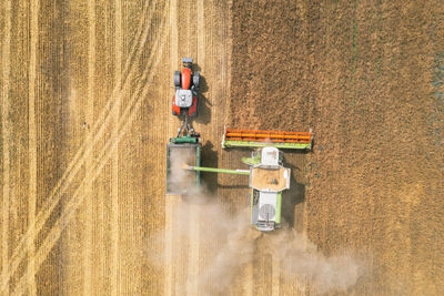 Harvesting of wheat in summer. harvesters working in the field. 