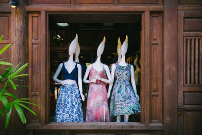 Rear view of clothes hanging on door