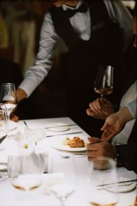 Midsection of woman preparing food on table