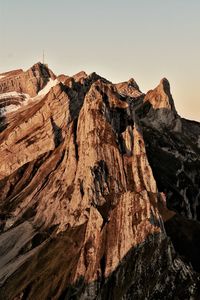 Scenic view of rocky mountains against clear sky in the morning