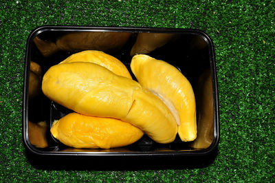 High angle view of yellow vegetables in container