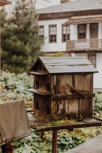 Close-up of old building by trees on field