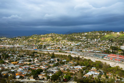 High angle view of buildings and trees against sky