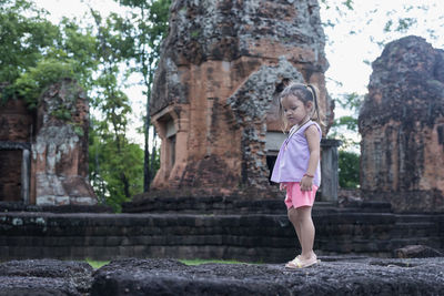 Rear view of woman standing by fountain