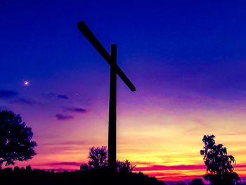 Silhouette windmill against sky during sunset