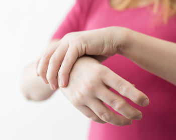 Close-up of hands over white background