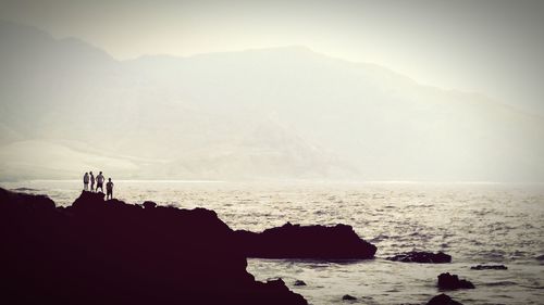 Scenic view of sea with mountain in background