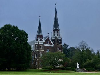 View of building and trees against sky