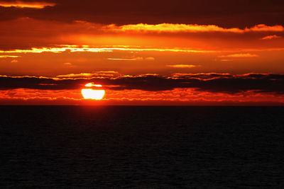 Scenic view of sea against romantic sky at sunset
