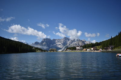 Scenic view of lake by mountains against sky