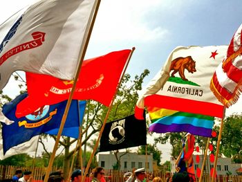 Low angle view of flags against sky