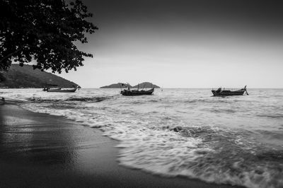 Boats moored at beach