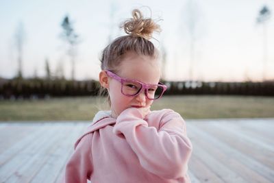 Portrait of cute girl with arms raised