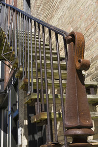 Close-up of metal railing against wall