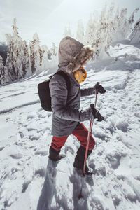 Full length of child on snow covered field