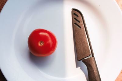 High angle view of red tomatoes in plate on table