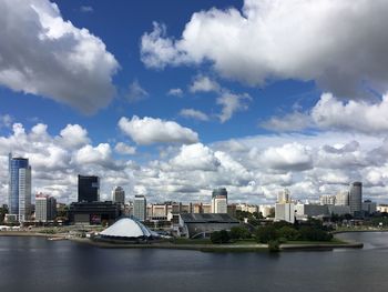 Svisloch river by cityscape against sky