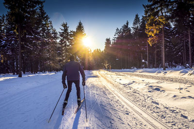 View of person skiing on snow covered landscape