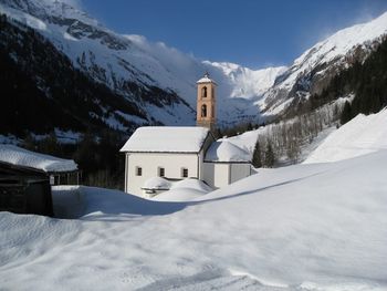 Church on snow covered field during winter