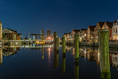 Scenic view of lake against clear sky at night