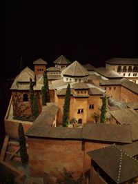 Illuminated buildings against sky at night