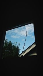 Low angle view of silhouette trees against sky