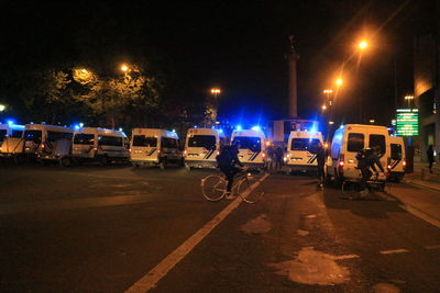 Cars on city street at night