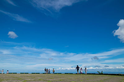 People on field against sky