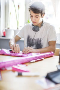 Teenage boy wrapping present