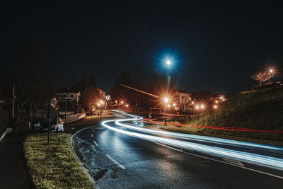 Light trails on road in city at night