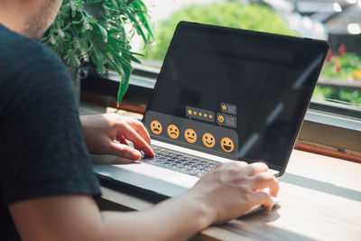 Midsection of woman using laptop