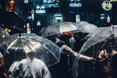 People on wet street at night