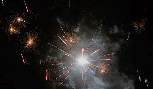 Low angle view of firework display at night