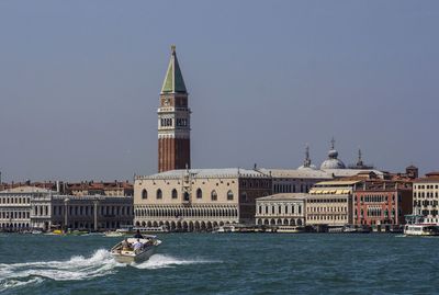 View of church at waterfront against clear sky