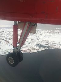 Airplane flying over snowy landscape during winter