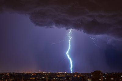 Lightning over cityscape at night