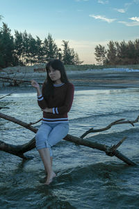 Full length portrait of woman in water