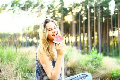 Portrait of smiling young woman in park
