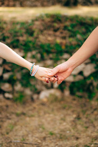 Midsection of woman hands on field