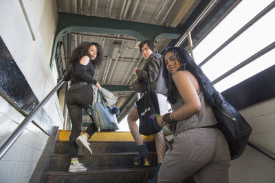 Friends at a train station in queens, new york