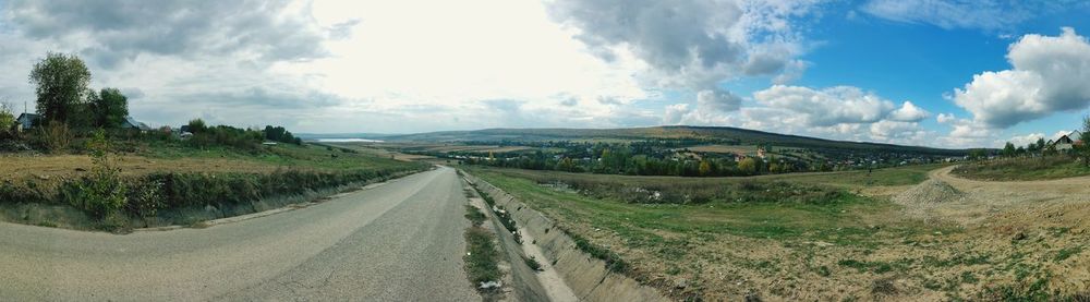 Panoramic view of empty road against sky