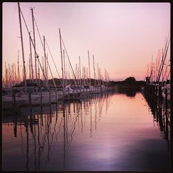 Reflection of sky in calm lake at sunset