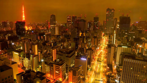 High angle view of illuminated buildings in city at night