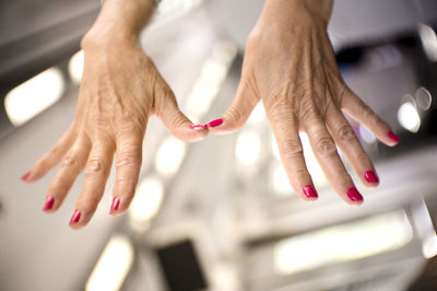 Close-up of cropped hands with nail polish