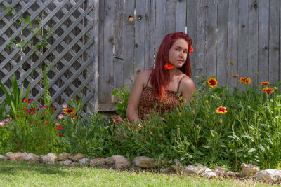 Portrait of woman with red flowers