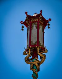 Low angle view of statue against clear blue sky