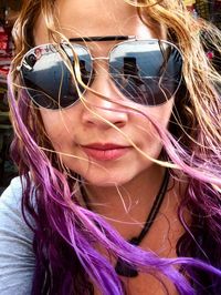 Close-up portrait of woman with purple hair