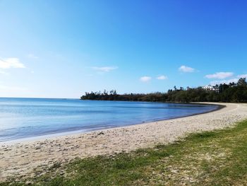 Scenic view of beach against blue sky