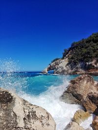 Scenic view of sea against clear blue sky