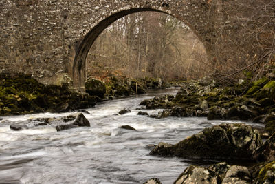 Scenic view of river flowing through arch